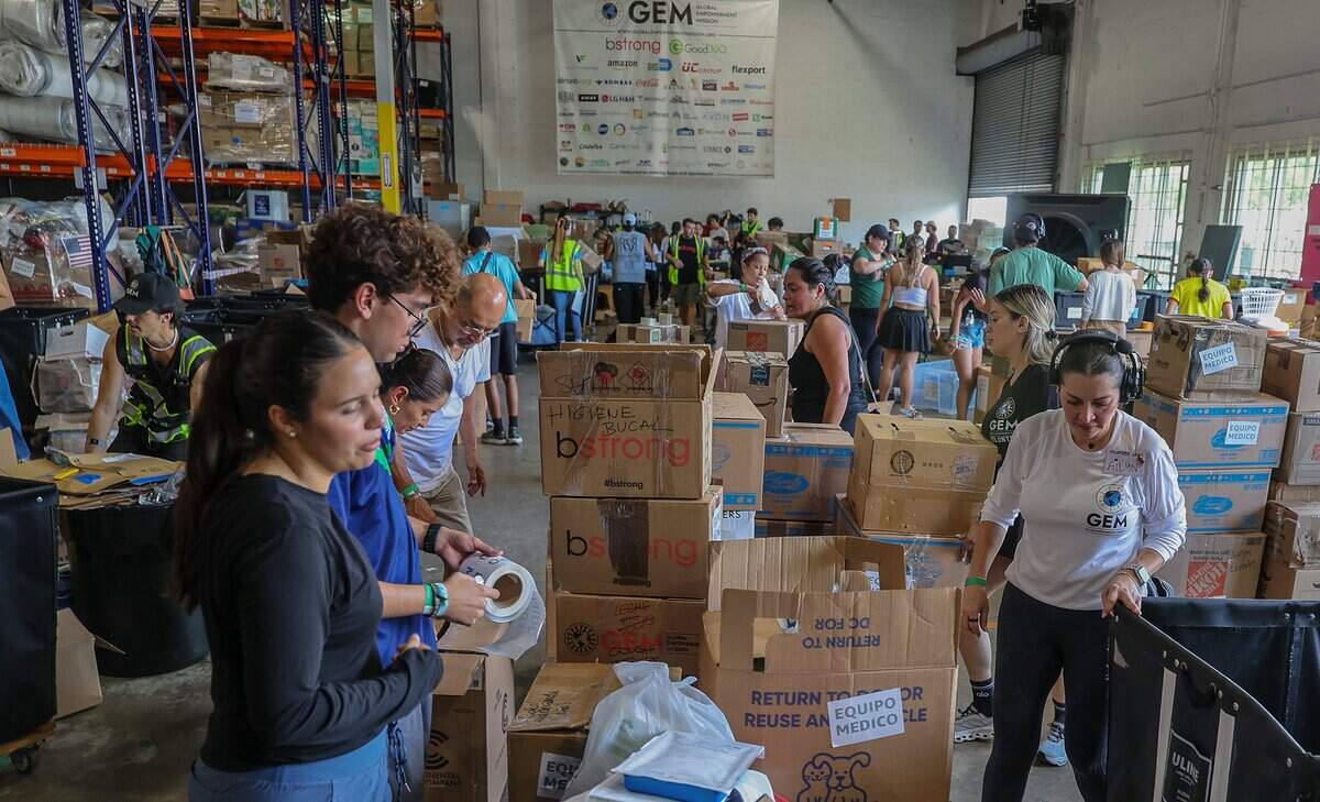 Volunteers filled boxes with supplies of aid for the victims in Colombia, as a press conference held by Michael Capponi, founder of the Global Empowerment Mission (GEM), was taking place to detail the urgent relief operations and a call for local volunteers and the need of donations a day after the devastating 7.4-magnitude earthquake that struck western Colombia, on August 10, at the organization’s headquarters in Doral, on Tuesday August, 2026.