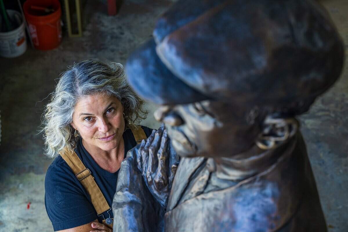 Cuban American sculptor Natalie Plasencia Calvo, who was born in Hialeah and raised in Miami Springs, stands next to her finished Glenn Curtiss Statue at the R.U.N. Art Foundry, that will be on display at the site of the Centennial Legacy Project-the Glenn Curtiss & June Bug Legacy Memorial, to honor aviation pioneer and the City of Miami Springs founder Glenn Hammond Curtiss, in Miami, on Monday June 15, 2026.