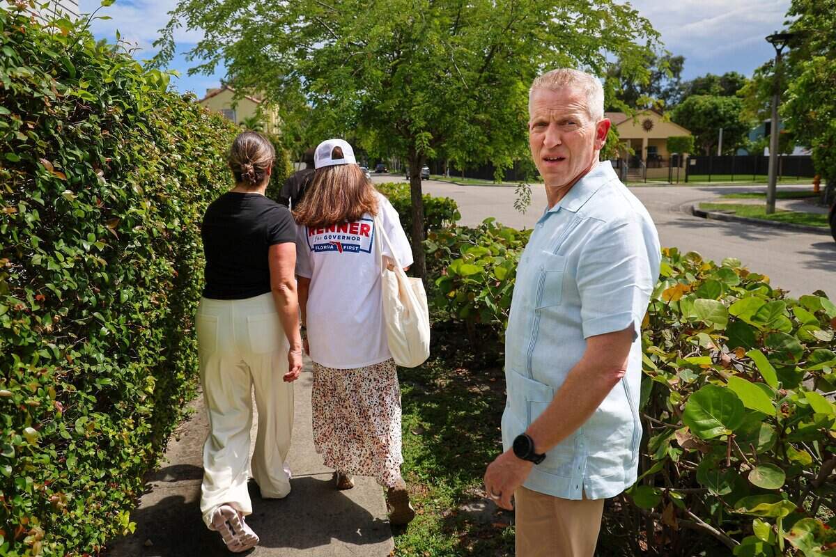 Republican gubernatorial candidate Paul Renner, right, glances back to get his bearings while campaigning in Miami's Little Havana on Tuesday, August 4, 2026.