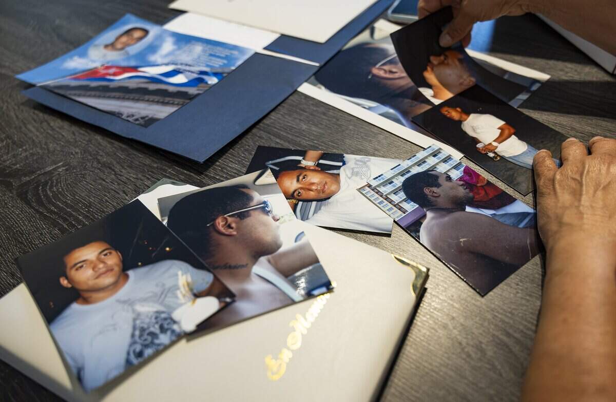 Vivian Texidor looks at photos of her late son, Raudel Sanchez, at her home on Wednesday, July 29, 2026, in Hialeah, Fla. Raudel, 21, was murdered on Aug. 27, 2009. His death remains a cold case, and no one has been arrested in connection with the crime.