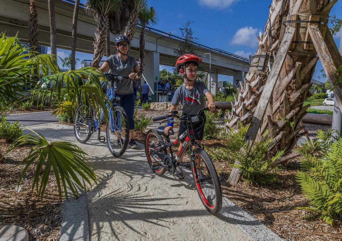 Kate Macia with her son AJ Macia enjoyed the nice weather biking from Pinecrest on the underline pathway during the Nikki Spoelstra Play Forest Grand Opening ceremony, in South Miami's section of The Underline, sponsored by Mrs. Spoelstra, on Saturday August 15, 2026.