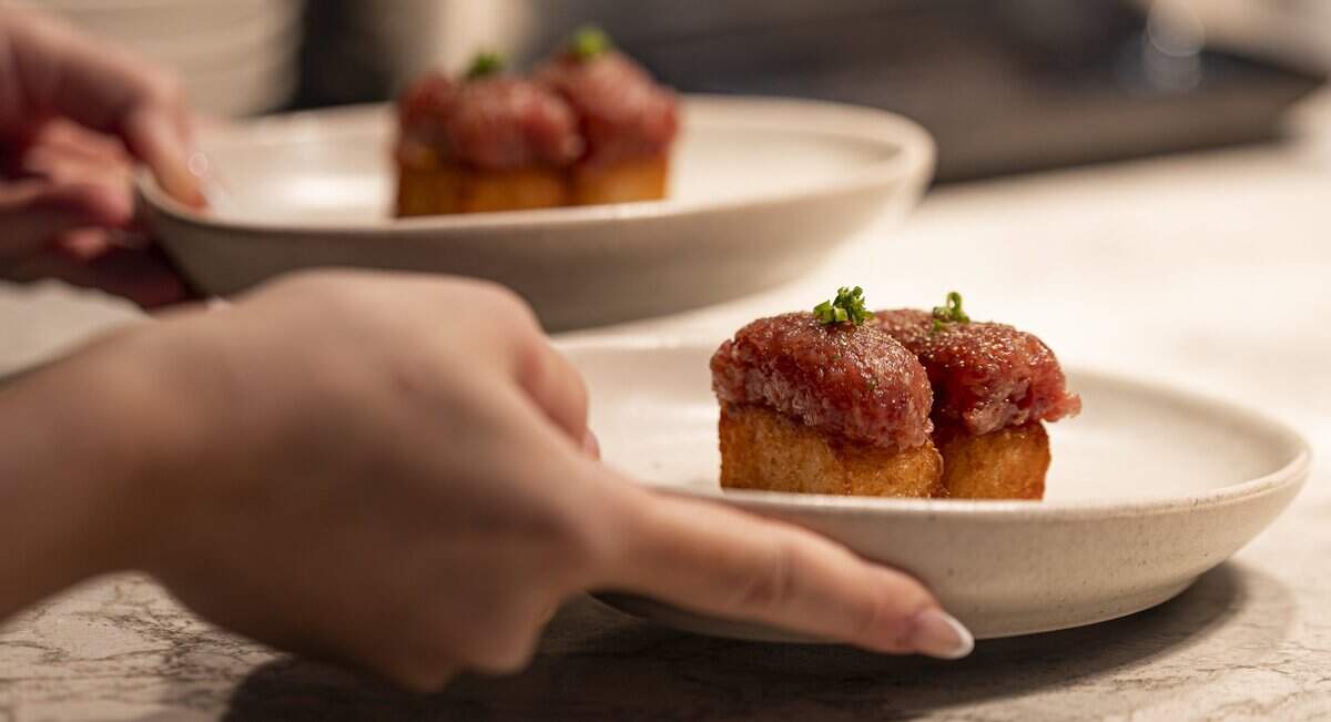 Tuna crispy rice is prepared at KYU on Wednesday, Aug. 26, 2026, in Miami, Fla.