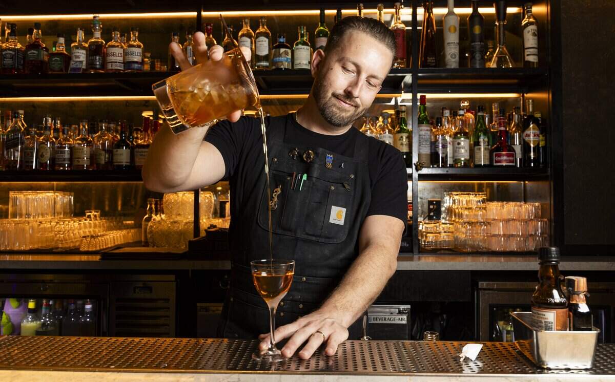Dan Cuellar, a lead bartender at KYU, where he has worked for six years, prepares a 'The World Is Yours' cocktail at the restaurant on Wednesday, Aug. 26, 2026, in Miami, Fla.