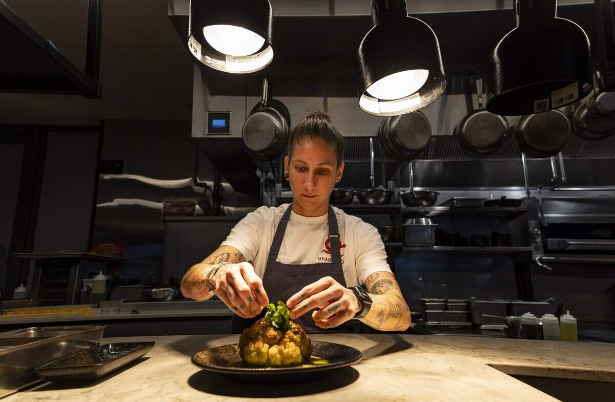 Monika Dominguez, a chef de cuisine at KYU who has worked at the restaurant for more than nine years, prepares roasted cauliflower on Wednesday, Aug. 26, 2026, in Miami, Fla.