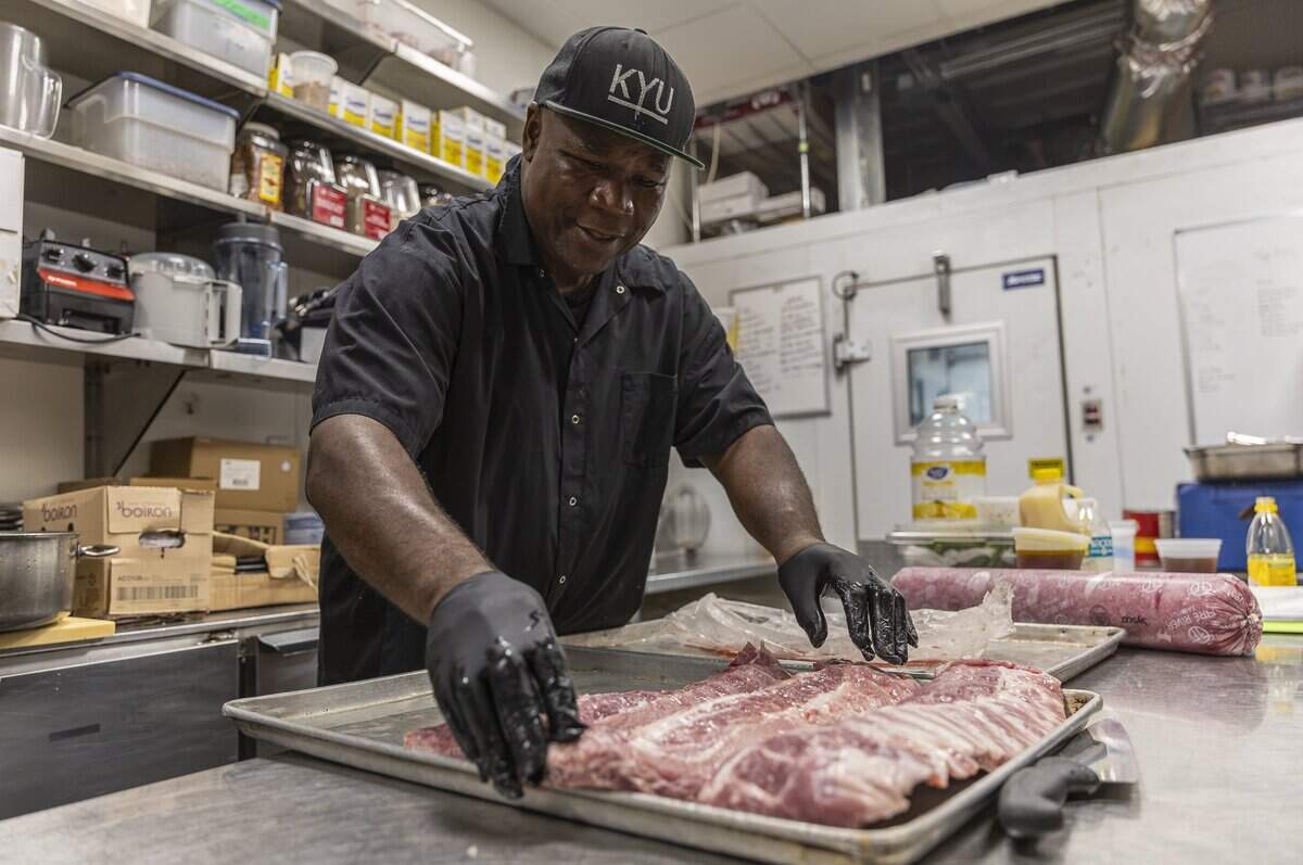 Jean Alva Petit Frere, 69, who has worked at KYU for ten years, prepares food on Wednesday, Aug. 26, 2026, in Miami, Fla.