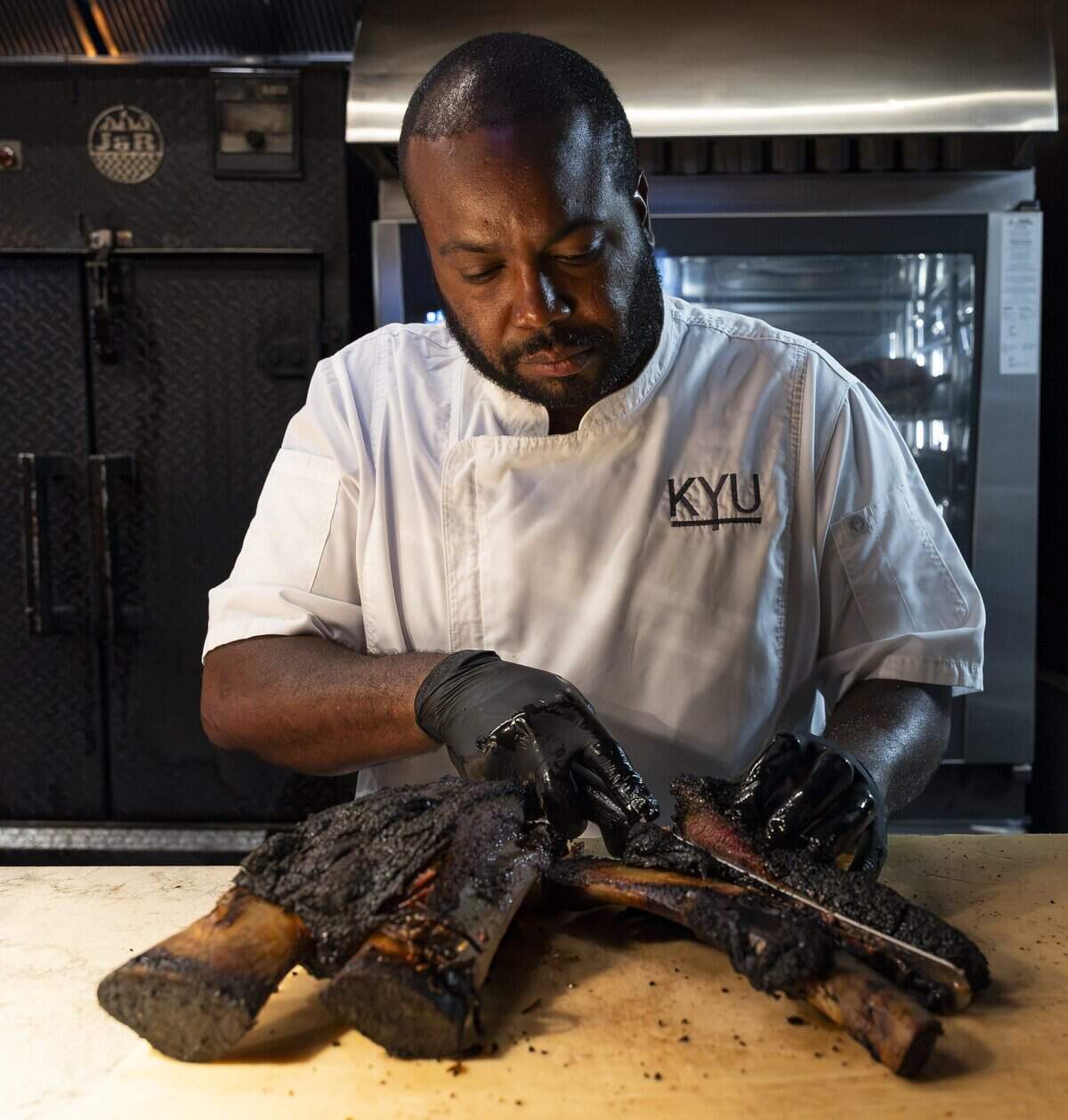 Chef Raheem Sealey prepares a beef short rib at his restaurant, KYU, on Wednesday, Aug. 26, 2026, in Miami, Fla.