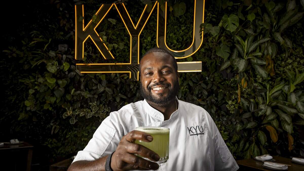 Chef Raheem Sealey holds a 'She-So Spicy' cocktail at his restaurant, KYU, on Wednesday, Aug. 26, 2026, in Miami, Fla.
