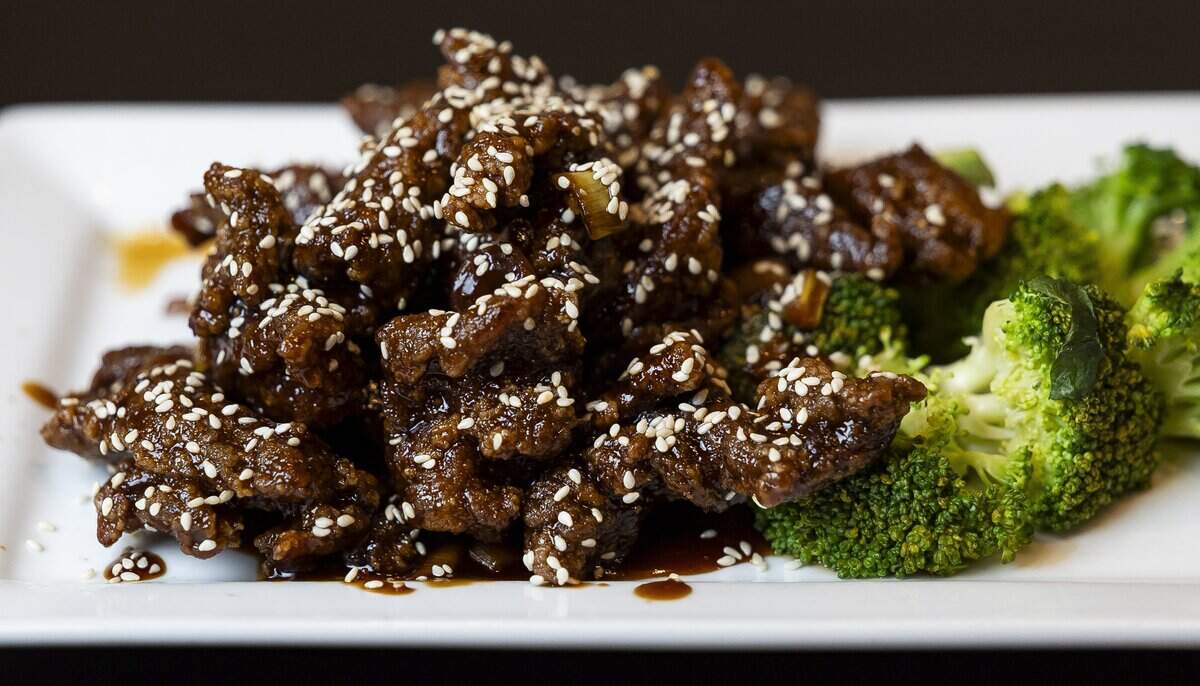 Chef Alex Kuk prepared Sesame Beef at his restaurant, Wan's Mandarin House, on Wednesday, Aug. 19, 2026, in Fort Lauderdale, Fla.
