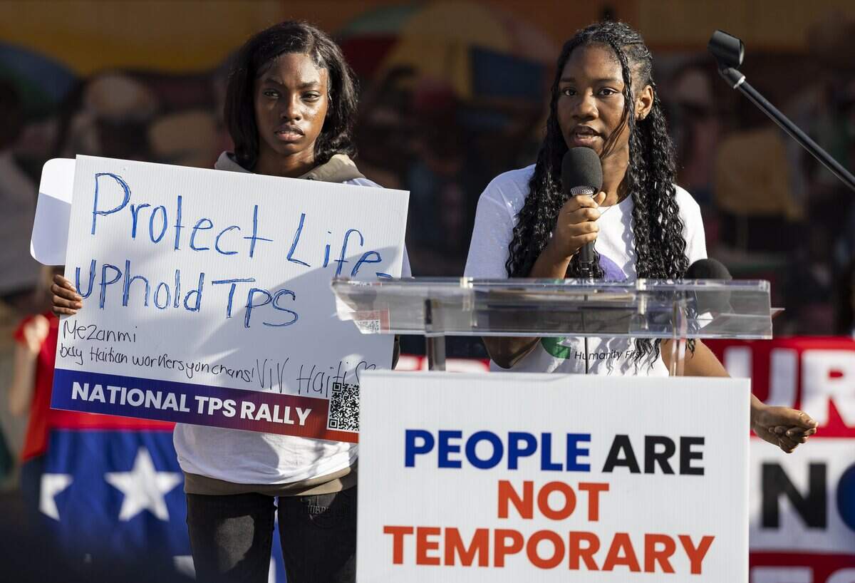 Mandy, an asylum seeker, speaking at podium and Beatrice Augustin, left, participate in a rally at the Little Haiti Cultural Center on Thursday, July 9, 2026, in Miami, Fla. The event called for protections for Temporary Protected Status (TPS) holders and other immigrants after the Trump administration stripped many of them of legal protections against deportation.