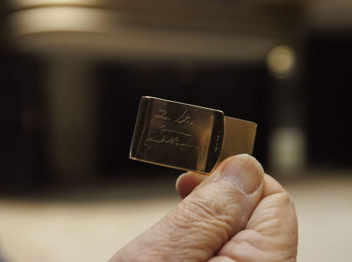 Stu Blumberg, the original general manager, holds a money cliche was gifted from Jack Benny that he still uses inside the old Playboy Theater on Thursday, Dec. 4, 2025, at the Castle Hotel in Miami Beach, Fla.