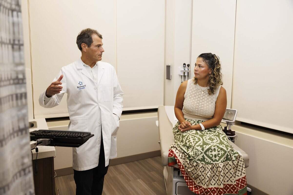 Dr. Bradley Safro, left, from Broward Health, talks with his new patient Diana Arias during the day on Thursday, July 30, 2026, at Memorial Primary Care in Plantation, Fla. Memorial and Broward Health have partnered to give patients access to doctors and nurses from both health systems at this center.