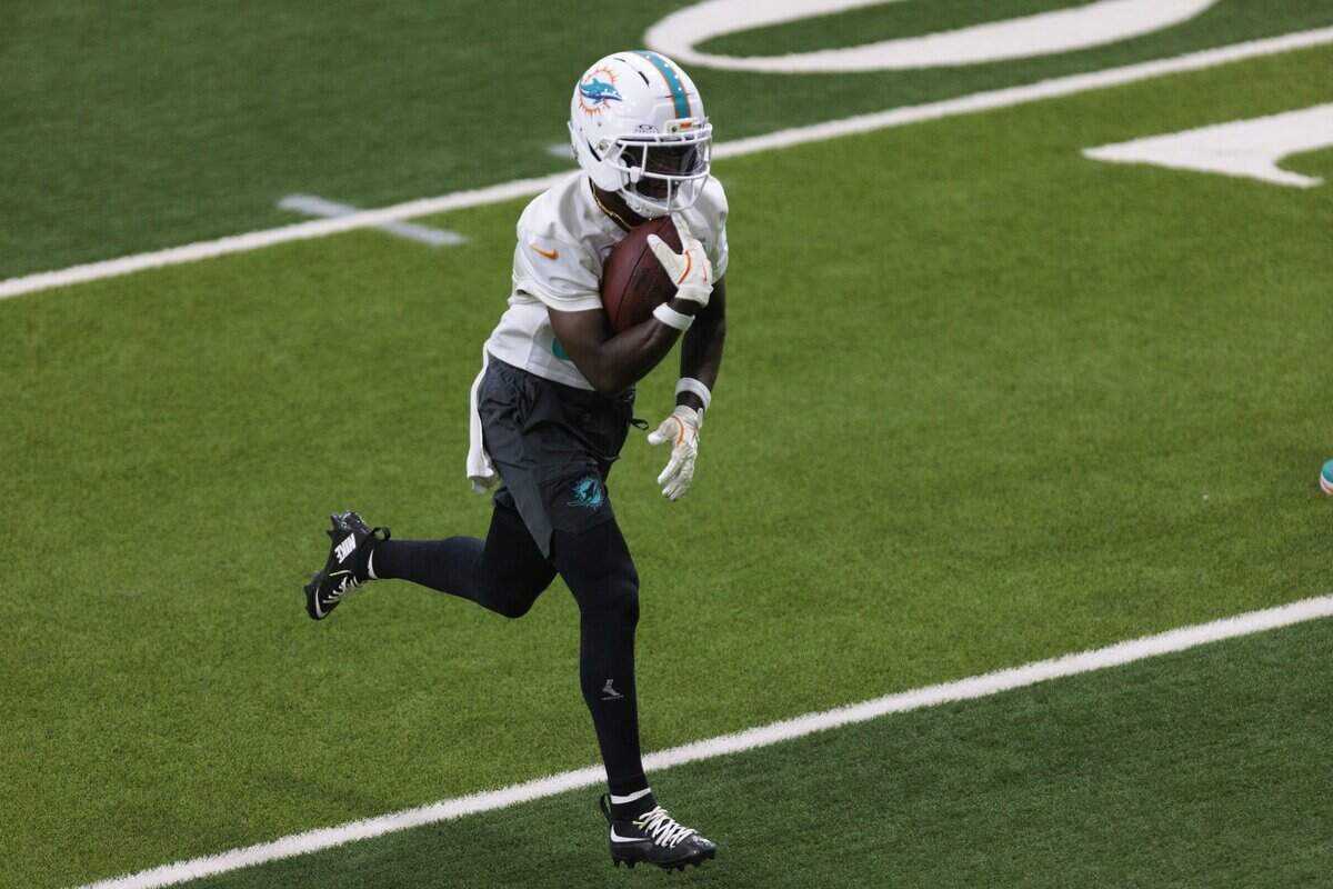 Wide receiver Tahj Washington (84) catches the ball during Miami Dolphins Training Camp on Thursday, Aug. 6, 2026, at Baptist Health Training Complex in Miami Gardens, Fla.