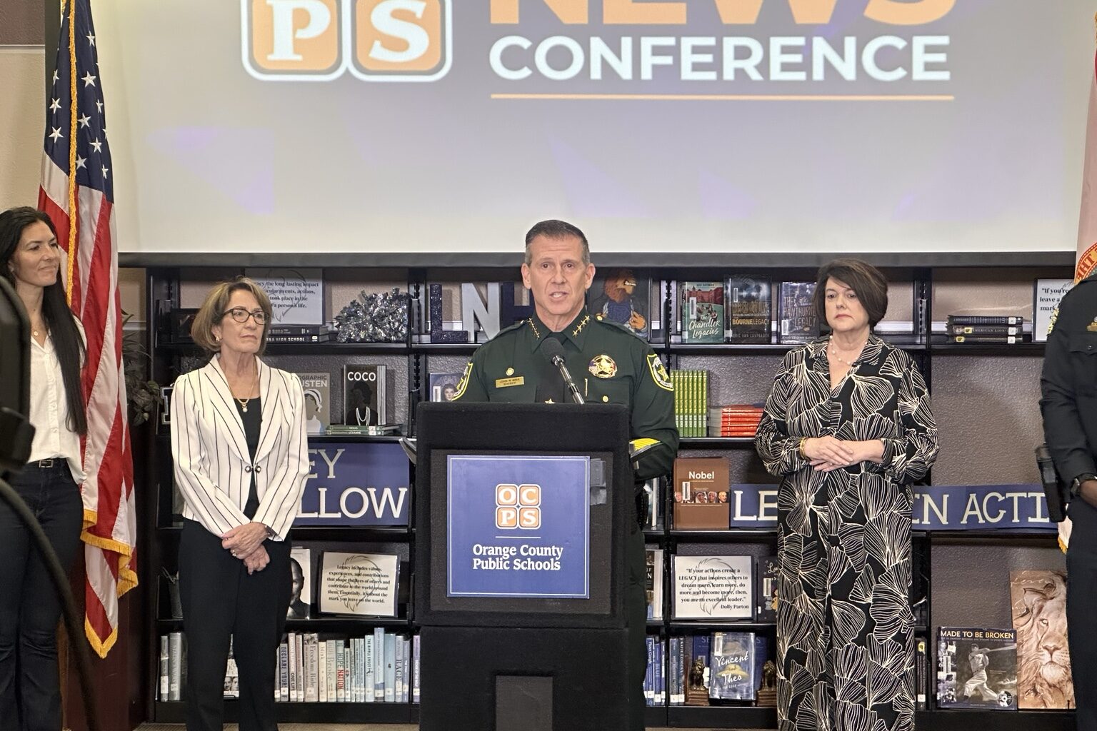 Orange County Sheriff John Mina speaks at podium during OCPS back-to-school news conference at Lake Nona High School