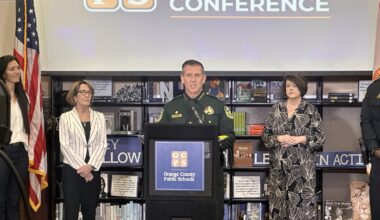 Orange County Sheriff John Mina speaks at podium during OCPS back-to-school news conference at Lake Nona High School