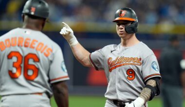 Baltimore Orioles' Tyler O'Neill (9) celebrates with first base coach Jason Bourgeois (36) after his RBI single off Tampa Bay Rays pitcher Bryan Baker during the 10th inning of a baseball game Saturday, Aug. 15, 2026, in St. Petersburg, Fla. (AP Photo/Chris O'Meara)