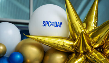 white, blue and gold balloons surrounding a big gold star and a whilte balloon with the words SPC Day