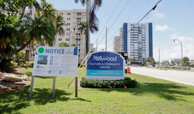 A sign, shown Thursday, alerts the public about an upcoming meeting related to a controversial high-rise project planned on public land at 1301 S. Ocean Drive in Hollywood. (Carline Jean/South Florida Sun Sentinel)