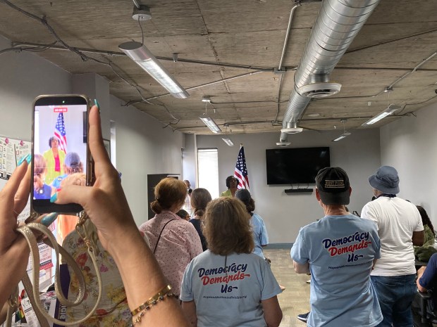 A supporter records state Rep. Angie Nixon, the 2026 Democratic nominee for U.S. Senate in Florida, speaking at a gathering of volunteers preparing to go door-to-door on her behalf in Hollywood on Sunday, Aug. 30, 2026. (Anthony Man/South Florida Sun Sentinel)