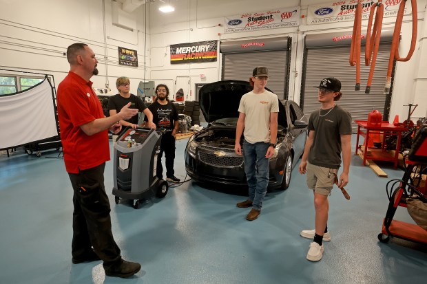 Teacher Carl Jones goes over the air-conditioning components of a car during the Automotive Maintenance & Light Repair program at Cooper City High School on Thursday, Aug. 20, 2026. Jones is a new automotive teacher who spent 25 years in the car repair business. (Mike Stocker/South Florida Sun Sentinel)