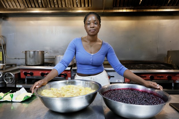 Roll and Dough owner Julie Pierre, of Fort Lauderdale, holds apple and blueberry fillings for her popular cinnamon rolls in Sunrise on Tuesday, Aug. 25, 2026. (Carline Jean/South Florida Sun Sentinel)