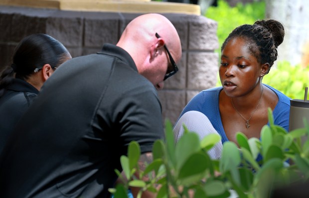 Roll and Dough owner Julie Pierre of Fort Lauderdale speaks to Sunrise Police after hundreds of her cinnamon rolls were stolen in Sunrise, Tuesday, Aug. 25, 2026. (Carline Jean/South Florida Sun Sentinel)