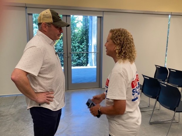 Alex Vindman, a candidate for the Democratic nomination for U.S. Senate, speaks to U.S. Rep. Debbie Wasserman Schultz after they both spoke at a get-out-the-vote rally sponsored by the Dolphin Democrats LGBTQ+ political club at the Pride Center at Equality Park in Wilton Manors on Saturday, Aug. 15, 2026. (Anthony Man/South Florida Sun Sentinel)