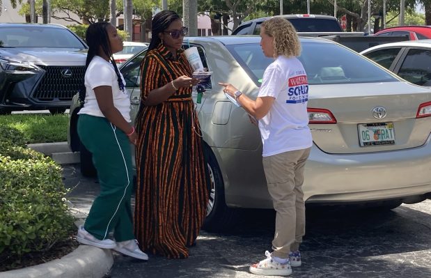 Verhonda Darrell, center, speaks with U.S. Rep. Debbie Wasserman Schultz, right, as her daughter Kenya Darrell looks on outside the early voting site at the African American Research Library and Cultural Center in Fort Lauderdale on Sunday, Aug. 16, 2026. They talked for more than 30 minutes. (Anthony Man/South Florida Sun Sentinel)