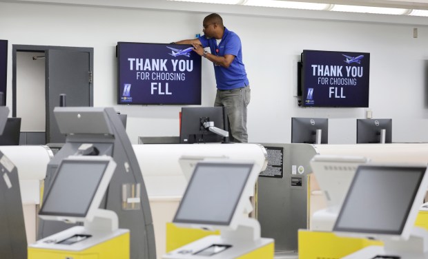 A man works near the ticket counter where Spirit Airlines was located at Fort Lauderdale-Hollywood International Airport on Wednesday, July 1, 2026. (Carline Jean/South Florida Sun Sentinel)