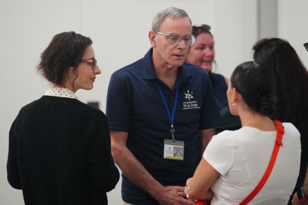 Rabbi Erica Rosenkranz, left, senior associate rabbi, and interim senior rabbi Cy Stanway, center, meet with congregants during a breakfast at Congregation B'nai Israel in Boca Raton, Wednesday, July 29, 2026. (Jim Rassol/Contributor)