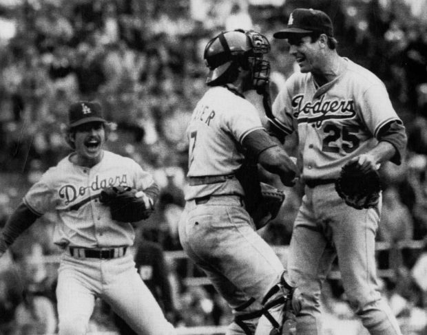10-5-78 -- Dodger third baseman Ron Cey (left) rushes out to join catcher Steve Yeager (center) in congratulating pitcher Tommy John after 4-0 win after the Phillies in game 2 of the National League playoffs Oct. 5. The Dodgers lead the best of five series, two games to none. UPI photo