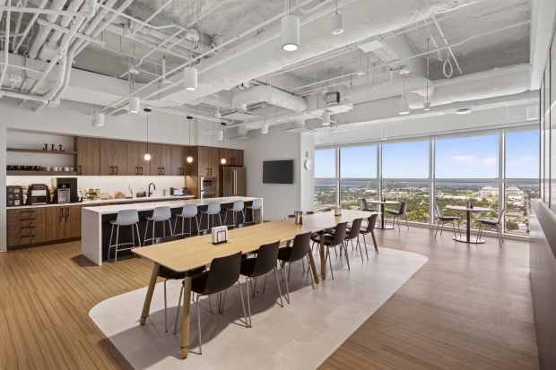A café and kitchen area in JLL's new Orlando office serves as a hub for employees and clients alike, offering space for informal meetings, events, and day-to-day connection. (Courtesy of JLL)