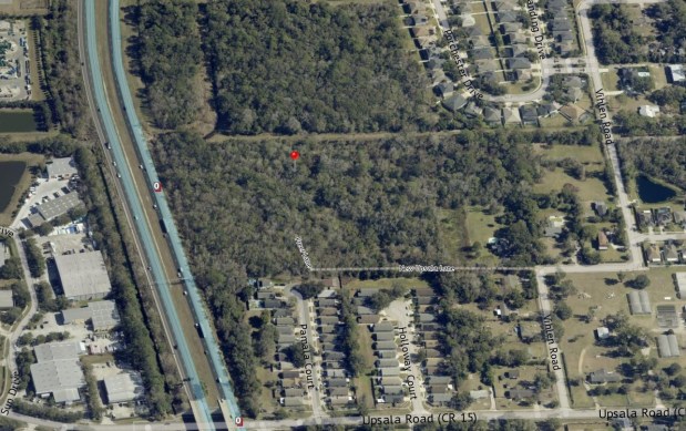 An aerial view shows the heavily wooded Freer Lane site, bounded by State Road 417 to the north and surrounding residential neighborhoods near Upsala Road. (Google Earth/County GIS)