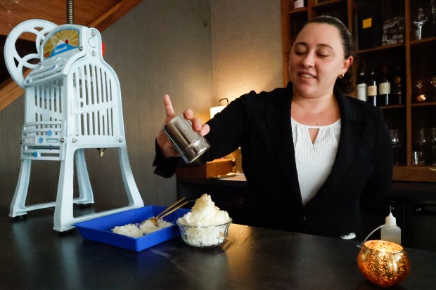 Kyleigh Sprigle adds kinako to a Kakigori, a shaved ice dessert created in The Salon space at the Michelin-starred restaurant in Winter Park. (Rich Pope/ Orlando Sentinel)
