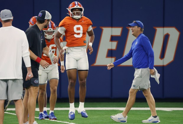 Florida quarterback Tramell Jones Jr. (9) and offensive analyst Steve Spurrier Jr. work together as the Gators opened preseason practices Aug. 5 at the UF practice facility in Gainesville. (Stephen M. Dowell/Orlando Sentinel)