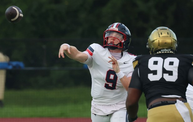 Lake Brantley quarterback Jackson Stecher (9) throws past Bishop Moore defender Deion Plummer (99) during the Lake Brantley High School at Bishop Moore Catholic High School preseason varsity football game in Orlando on Friday, August 14, 2026. (Stephen M. Dowell/Orlando Sentinel)
