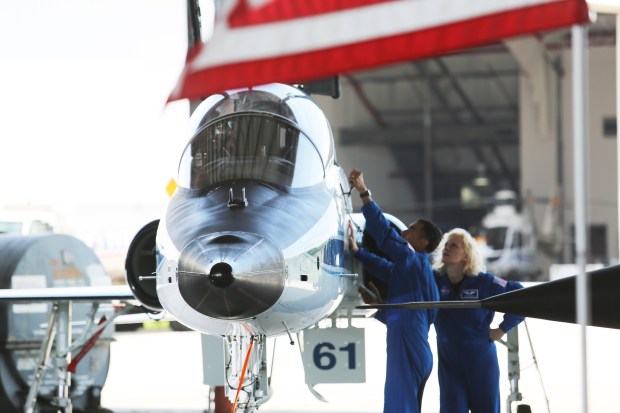 NASA astronauts Raja Chari and Deniz Burnham inspect one of twof T-38 jets that were on display in front of the XLV Hangar at the Shuttle Landing Facility at Kennedy Space Center on Friday, Aug. 14, 2026. The duo were on hand for an event announcing the Max Power air show coming to KSC on Nov. 7-8. (Richard Tribou/Orlando Sentinel)