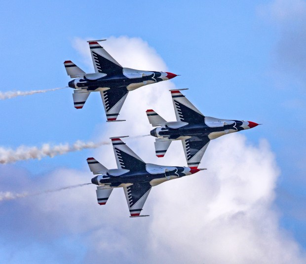A trio of F-16 Fighting Falcons aircraft from the U.S. Air Force Thunderbirds Air Demonstration Squadron fly in formation over Orlando Sanford International Airport during their show-site aerial survey and arrival maneuvers in 2023. (Joe Burbank/Orlando Sentinel)