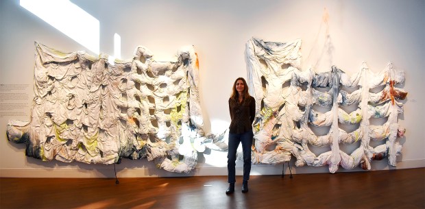Artist Cynthia Mason is photographed in front of her "soft paintings" during opening night of the "Experience Contemporary: A Wrench in the Gears" exhibition at Casselberry Arts Center. (Chelsea Smith/Courtesy of Casselberry Arts)