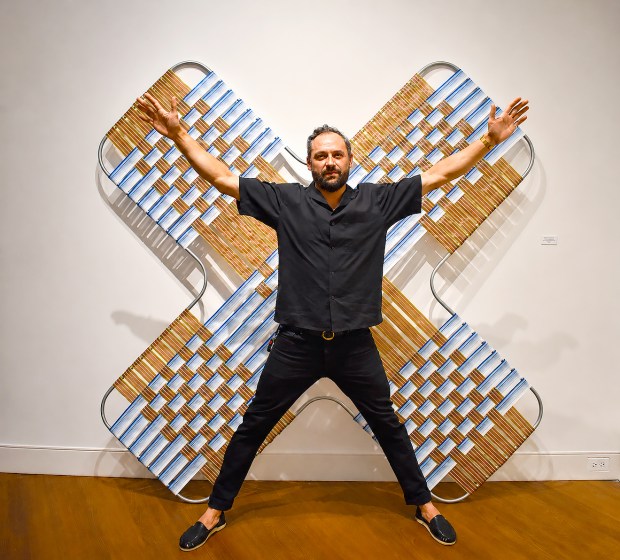 Artist Matthew Wicks is pictured in front of one of his deconstructed lawn chairs during opening night of the "Experience Contemporary: A Wrench in the Gears" exhibition at Casselberry Arts Center. (Chelsea Smith/Courtesy of Casselberry Arts)