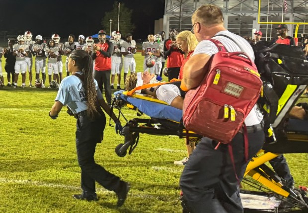 Medical personnel take Edgewater quarterback Joe Aicher off the field after he was injured during Friday night's Kickoff Classic game against Armwood. Aicher was moving his arms and legs and was talking, but was complaining of neck pain. The game was called after the injury, ending in a 14-14 tie. (Chris Hays/Orlando Sentinel)