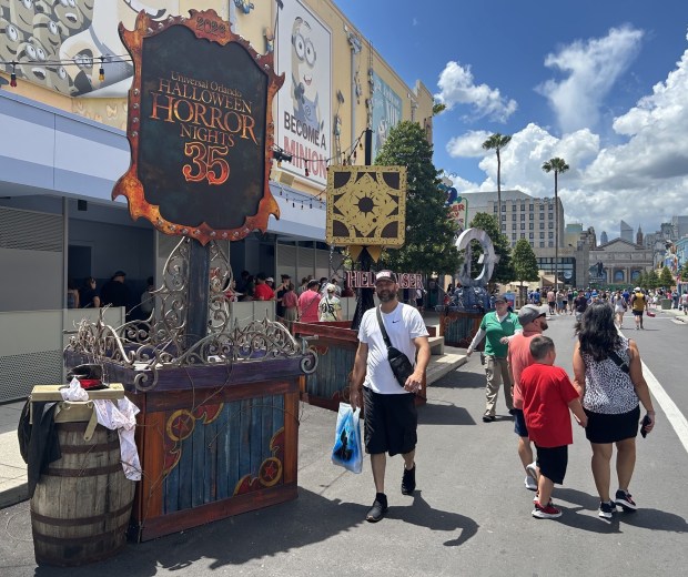 Universal Orlando visitors walk through preparations for Halloween Horror Nights, which launches at Universal Studios Florida theme park on Aug. 27. (Dewayne Bevil/Orlando Sentinel)