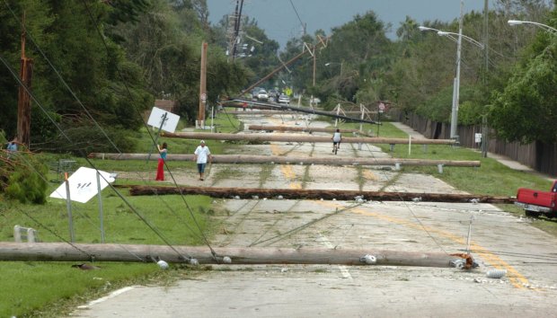 Utility poles blown over by Hurricane Charley lie across Lake Margaret Drive in southeast Orlando in this 2004 file photo. (Orlando Sentinel file)