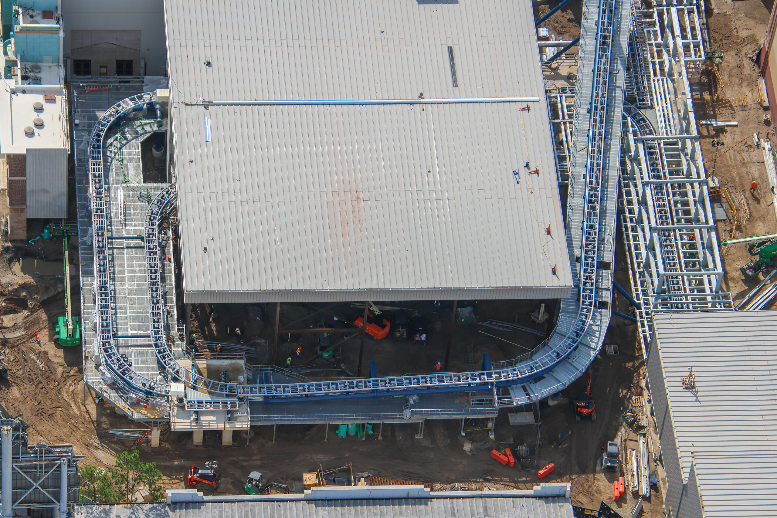 Aerial photographer bioreconstruct shared new views of the sprawling construction site, offering some of the clearest looks yet at the attraction’s interconnected track, station, launch, and maintenance areas.
