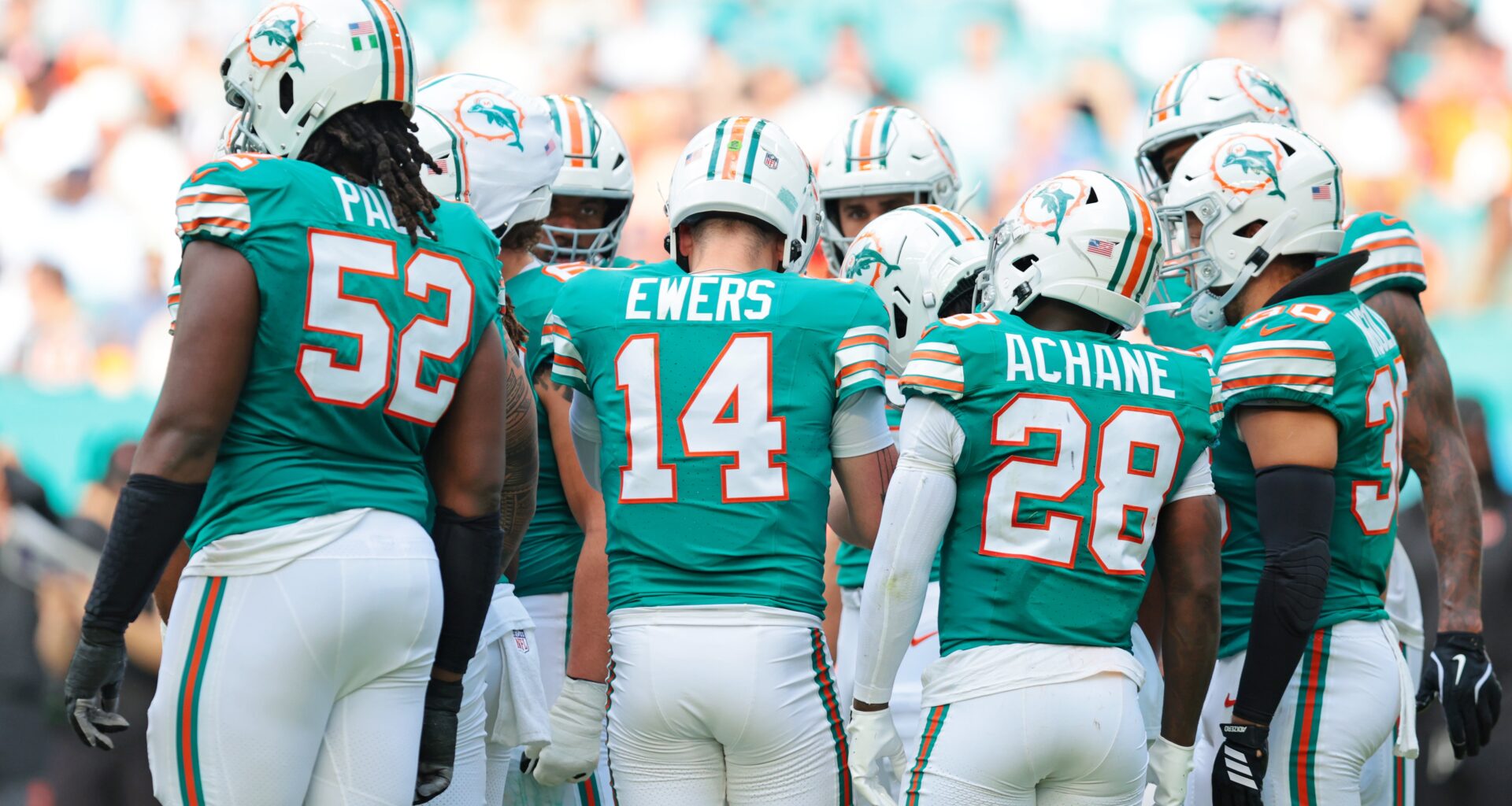 Dec 21, 2025; Miami Gardens, Florida, USA; Miami Dolphins quarterback Quinn Ewers (14) huddles up with teammates during the second quarter against the Cincinnati Bengals at Hard Rock Stadium.