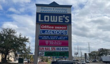 Waters Crossing sign on West Waters Avenue showing Lowe’s, Office Depot, LaserOps, T-Mobile and other tenants.