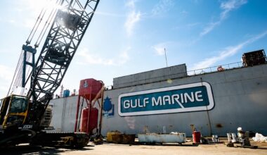 Gulf Marine shipyard in Tampa with a large crane beside the company’s waterfront industrial facility.