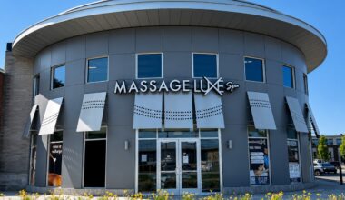 MassageLuXe spa storefront with exterior signage and landscaped entrance