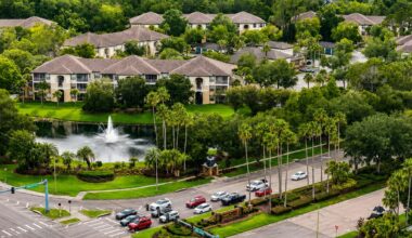 Aerial view of Mission Village in Tampa’s Palm River area, with residential buildings, a pond and surrounding roads.