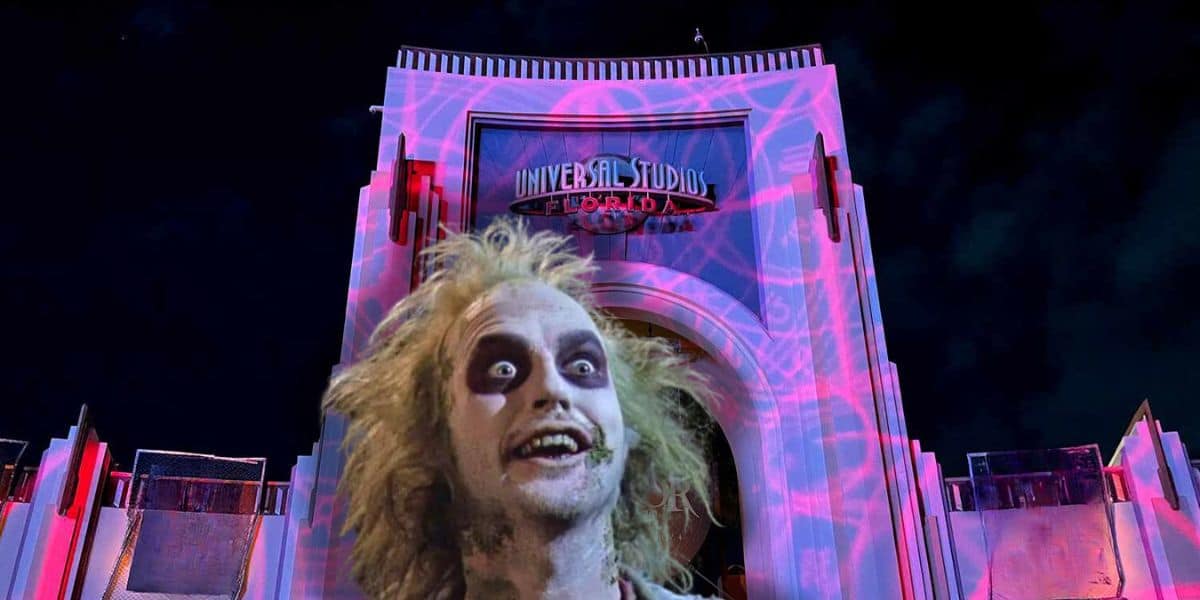 An illuminated archway at Universal Studios Florida is projected with psychedelic patterns at night. In the forefront, a figure with disheveled hair, pale skin, and dark eye makeup grins wide, resembling a character from a horror comedy movie—a perfect scene for Halloween Horror Nights.