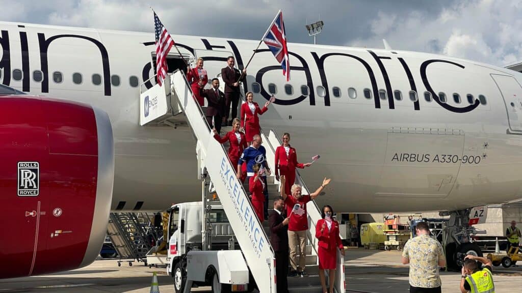 exterior of a large plane with people standing on a staircase